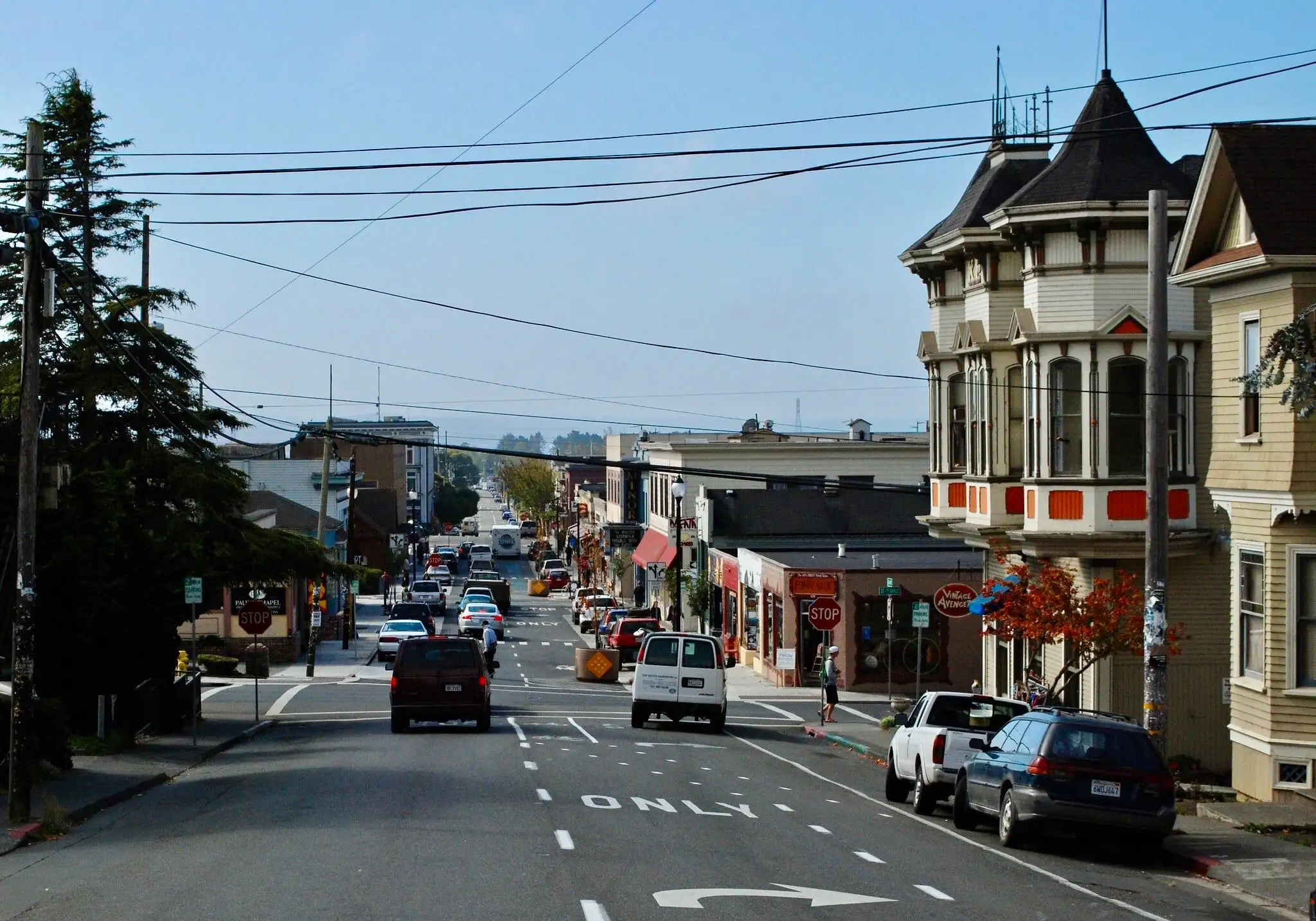 Historic storefronts and Victorian buildings along a sunny street in downtown Arcata