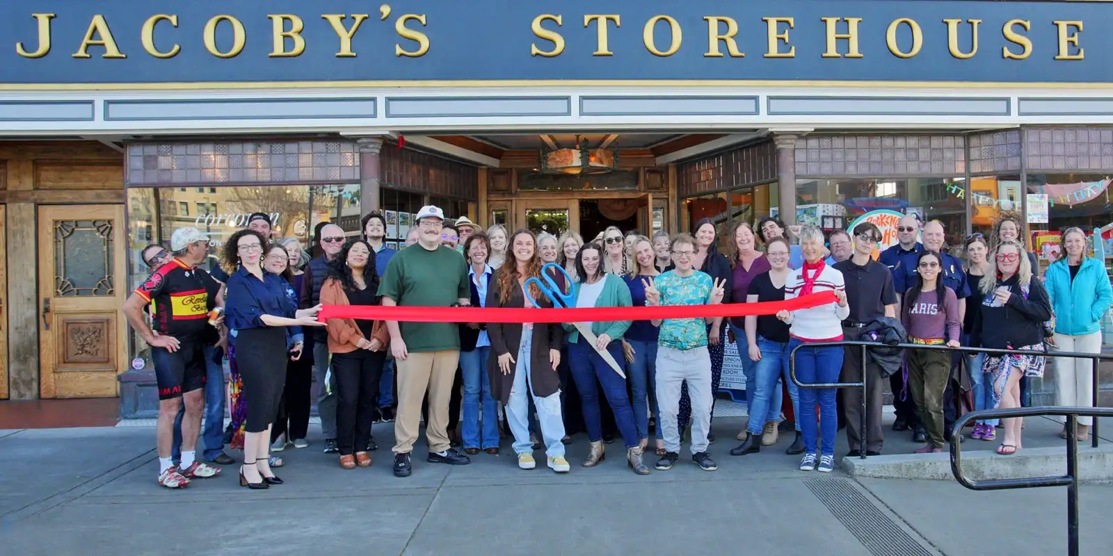 Chamber members, city staff, and neighbors cut a red ribbon outside Jacoby’s Storehouse on the Arcata Plaza