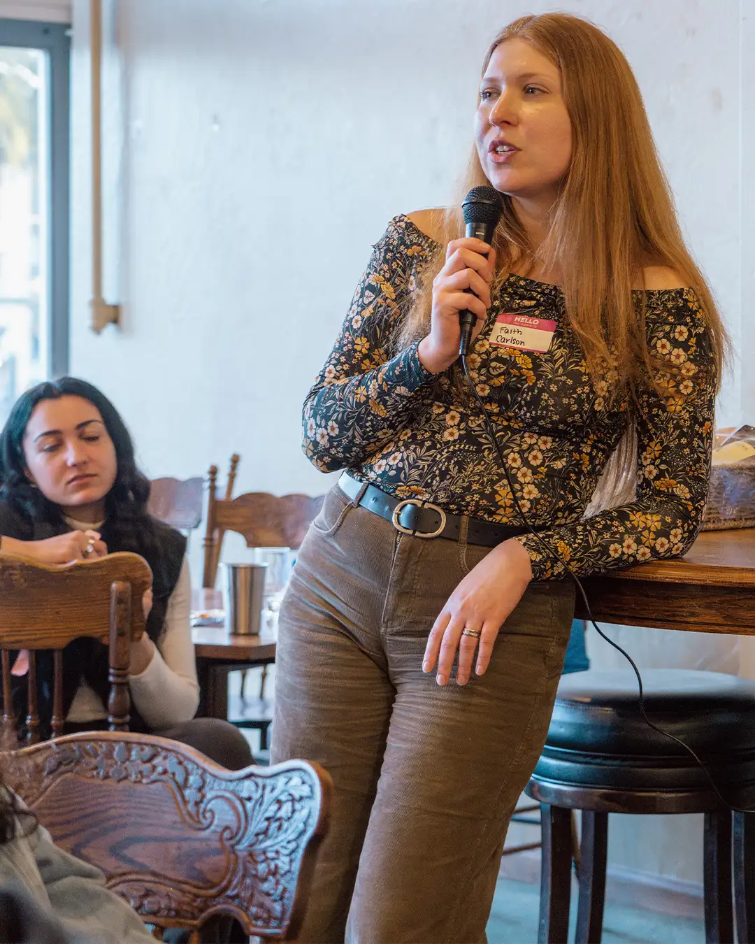 A woman speaks on a microphone at an Arcata Chamber of Commerce Young Professionals Network event