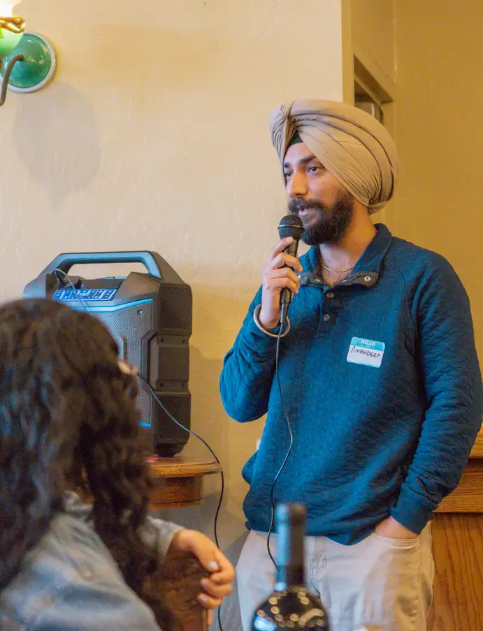 A man speaks on a microphone at an Arcata Chamber of Commerce Young Professionals Network event